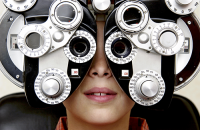 routine eye exam | photo of young boy getting an eye exam