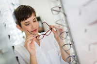 low price vs. high price glasses | photo of young woman shopping for glasses