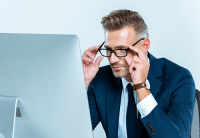 glasses to match your needs | photo of corporate guy siting in formt of large screen computer