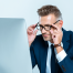 glasses to match your needs | photo of corporate guy siting in formt of large screen computer