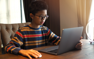 Computer Vision Syndrome | photo of Asian boy looking at laptop screen