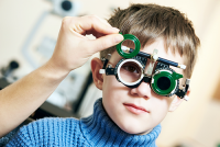 eye exams for children | photo of young boy getting an eye exam