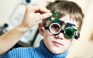 eye exams for children | photo of young boy getting an eye exam