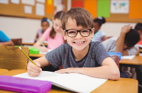 school children wearing glasses | photo of boy wearing glasses in class