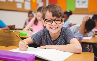 school children wearing glasses | photo of boy wearing glasses in class