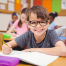 school children wearing glasses | photo of boy wearing glasses in class