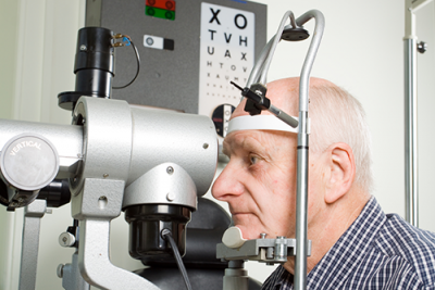 dilated eye exam | photo of oldr gentleman getting an eye exam