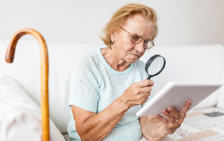 Low Vision | photo of older woman using a magnifying glass