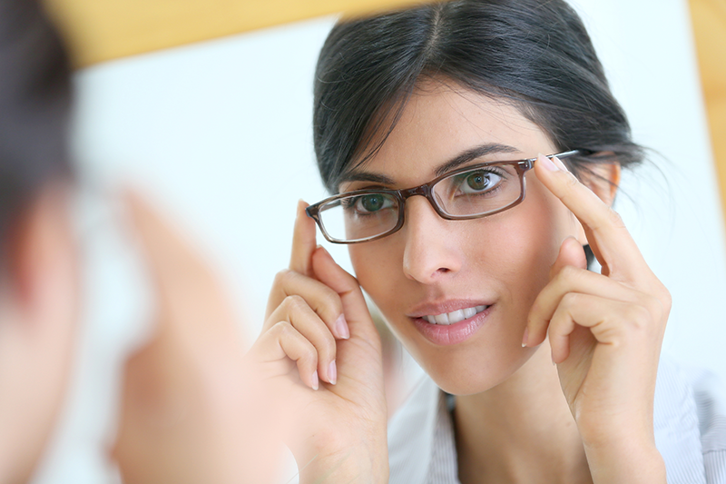 patient forms | photo of attractive woman trying on eyeglasses