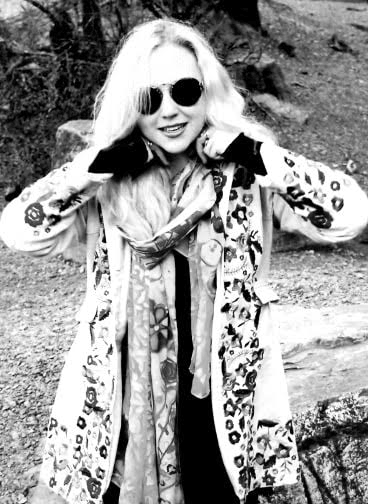 blank and white photo of blonde wearing designer sunglasses