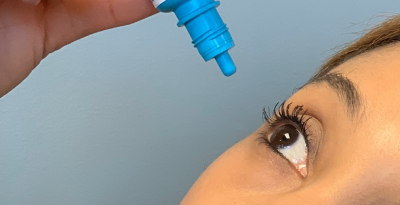 dry eye | photo of woman putting drops in her eye